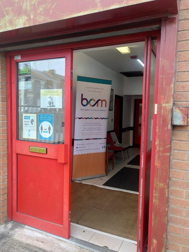 Red double doors: entrance to Soho Community Hall